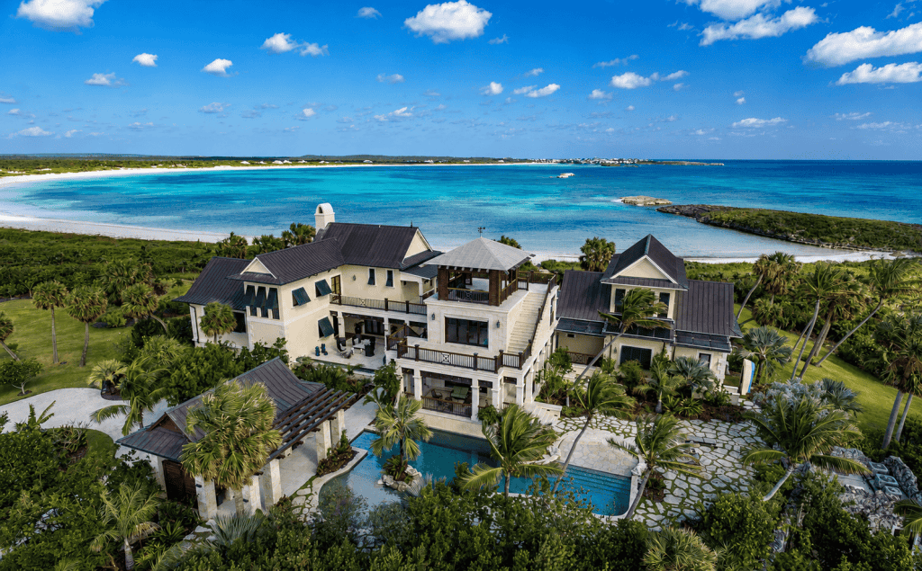 Luxury beachfront villa with pool overlooking the Bahamas ocean.