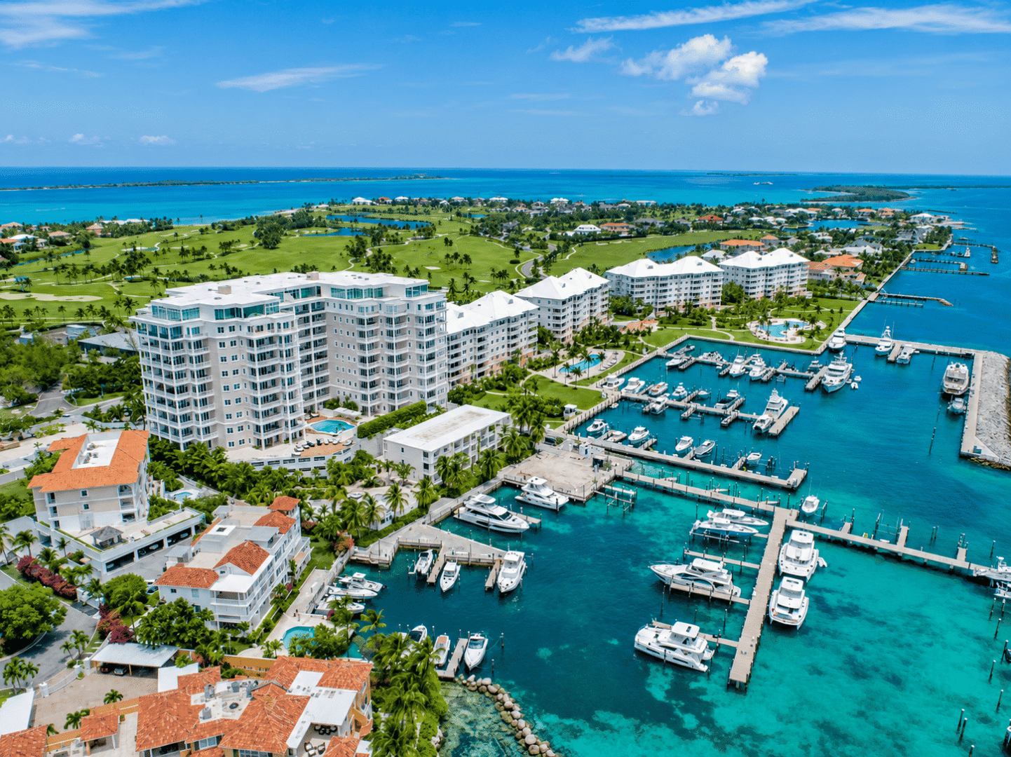 Luxury marina with yachts and resort buildings in Bahamas.