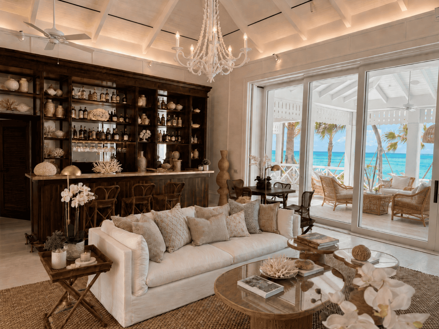 Elegant living room with ocean view, white sofa, and tropical decor in Bahamas.