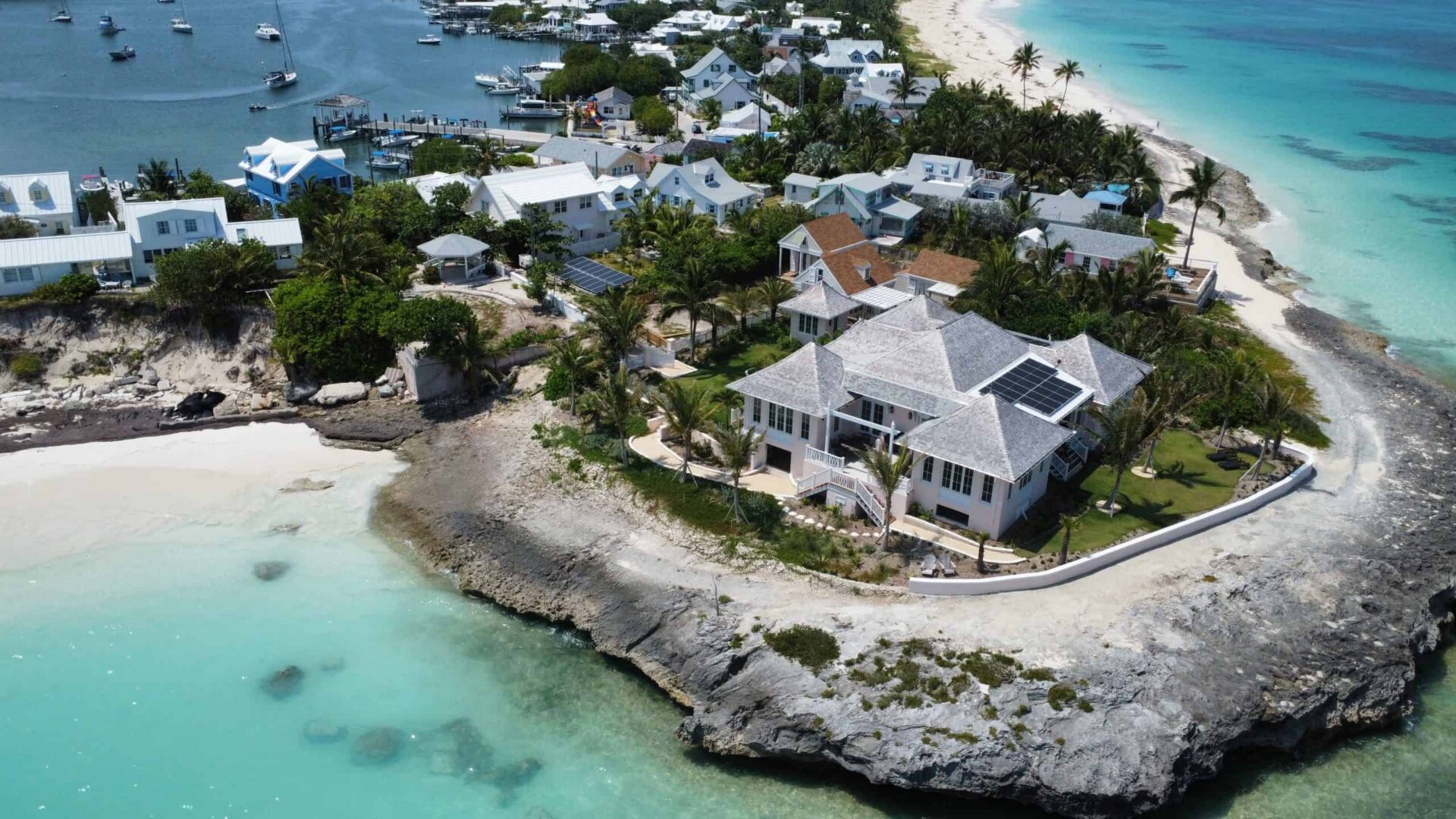 Luxury private residence on Hope Town's shoreline with ocean views and tropical landscaping.