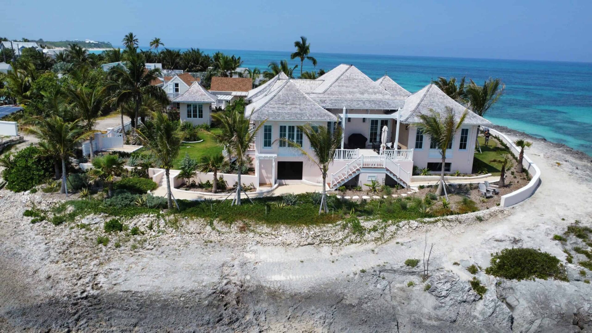 Luxury private residence on Hope Town's beachfront with ocean views and tropical landscaping.