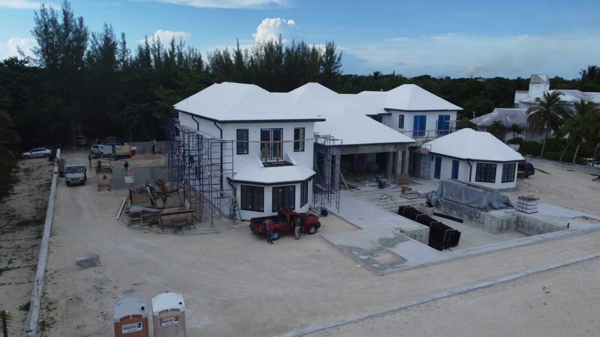 Under construction luxury villa with white roof and modern design in Bahamas.