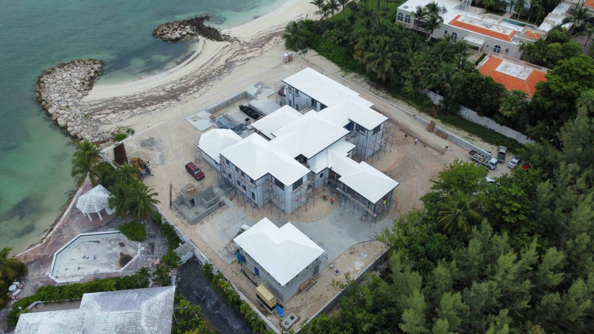 Aerial view of a modern beachfront villa under construction in Bahamas.