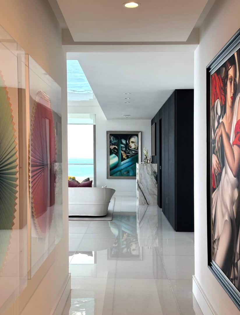 Modern interior with ocean view, artwork, and sleek design elements.