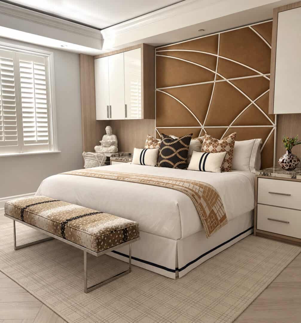 Elegant bedroom with modern decor, plush bed, and decorative pillows.