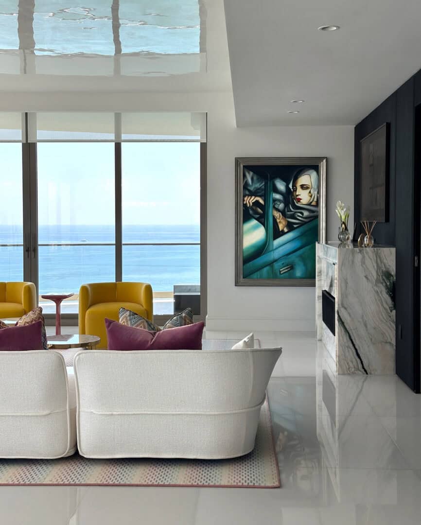 Modern living room with ocean view, stylish furniture, and contemporary art.